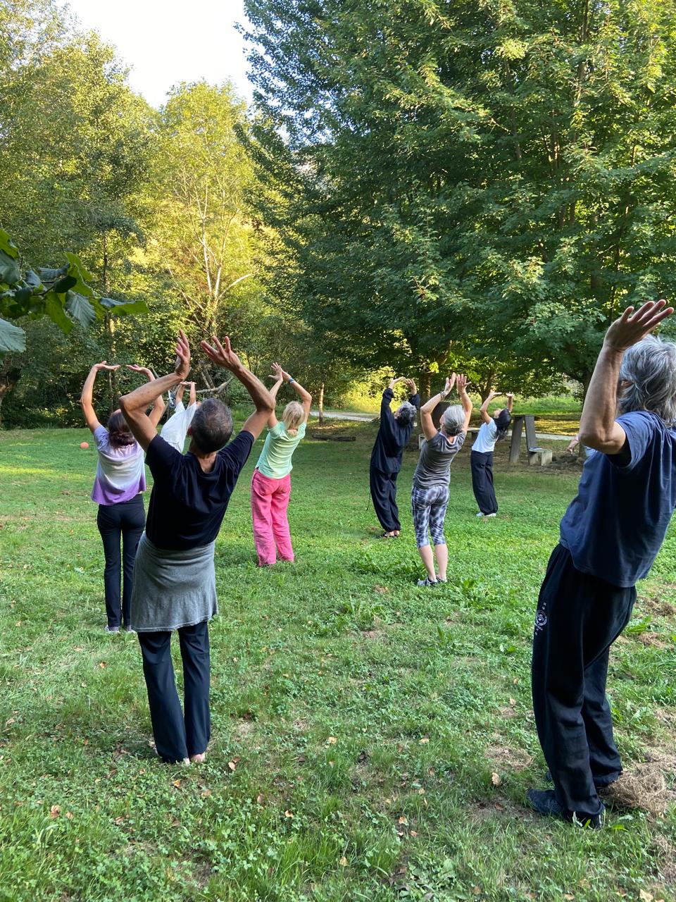 Group practice with arms raised to the sky